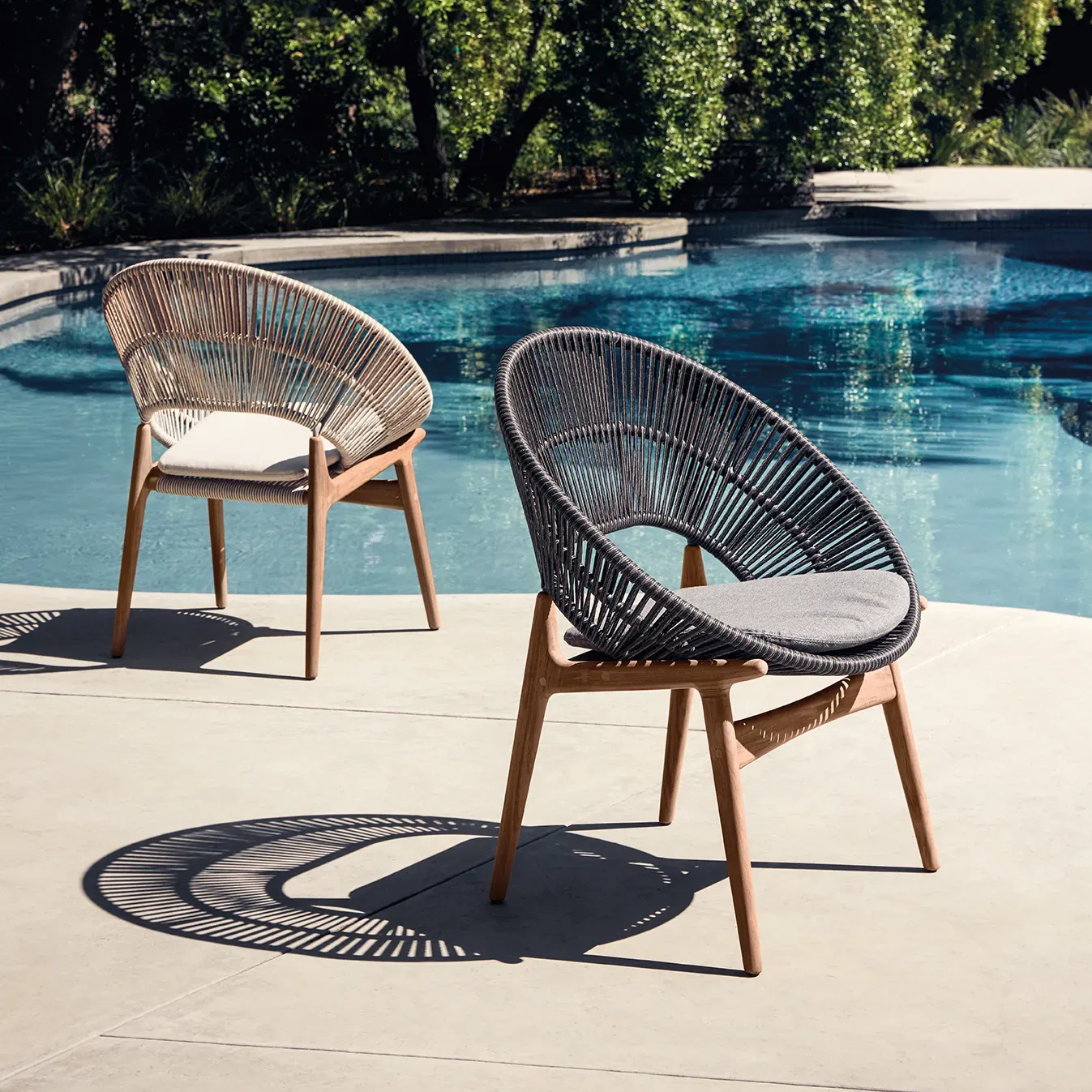 two bora dining chairs next to swimming pool