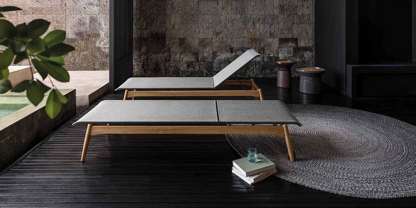 a pair of sway loungers in a spa setting with deco rug and coso tables
